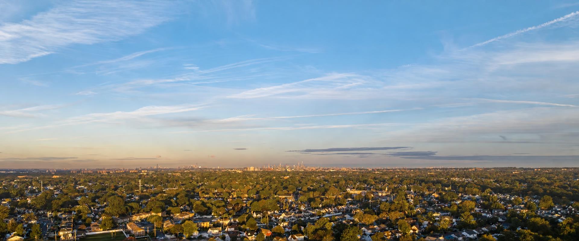 Aerial view of Long Island neighborhoods with the NYC skyline on the horizon